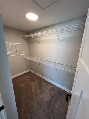 a walk in closet with shelves and a light at Ocean View Oasis in Campbell River