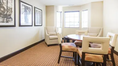 a dining room with a table and chairs at Staybridge Suites West Edmonton by IHG in Edmonton