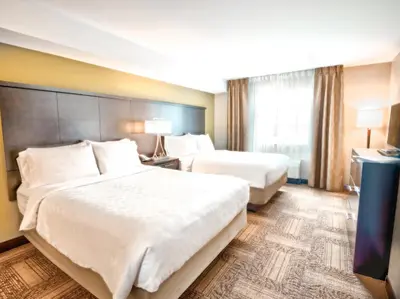 a hotel room with two beds and a window at Staybridge Suites West Edmonton by IHG in Edmonton