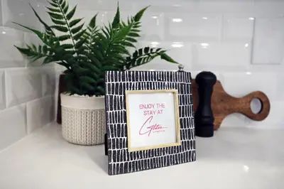 a book sitting on a counter with a plant at Stylish Home with AC, 3 King Beds, Garage, Disney in Edmonton