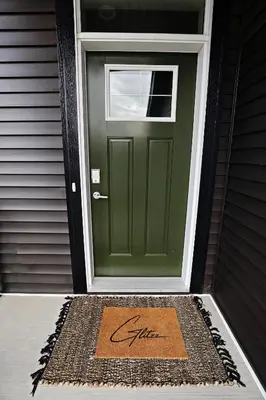 a green door with a sign that says fix at Stylish Home with AC, 3 King Beds, Garage, Disney in Edmonton