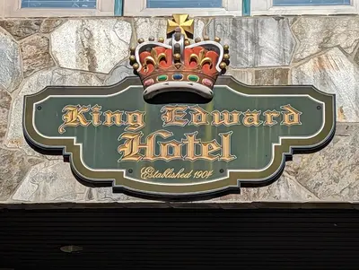 a sign for a hotel with a crown on it at King Edward Hotel in Banff