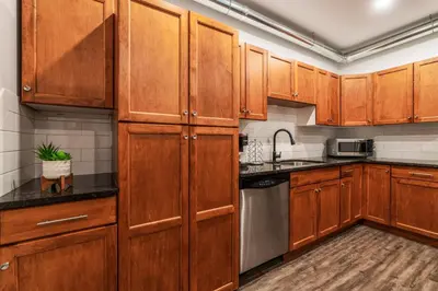 a kitchen with wooden cabinets and stainless steel appliances at Heaven's Haven in Vernon