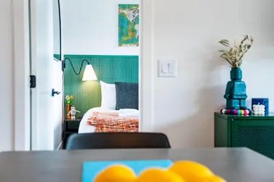 a room with a table and a bedroom with a bed at The Ski Shanty by Revelstoke Vacations in Revelstoke