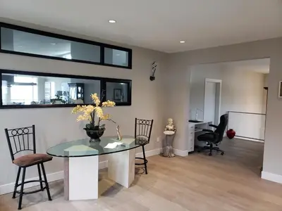 a living room with a glass table and chairs at EdgeWater Chemainus in Chemainus