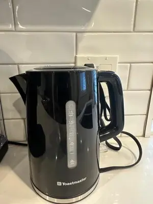 a black coffee pot sitting on a kitchen counter at Bright and cozy modern home in Vancouver - central to YVR-Downtown - Free Private Parking in Vancouver