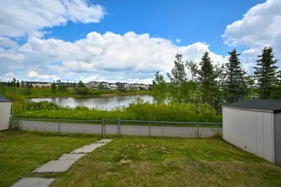 a view of a body of water with houses at 52-3 Bed Suite On Lake Central Ac By Airport in Calgary