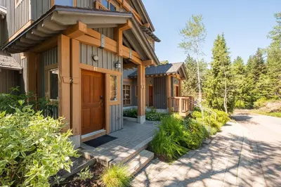 a house with a porch and a driveway at Taluswood Bluffs by Outpost Whistler in Whistler