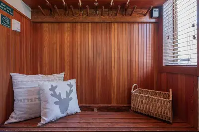 a porch with two pillows sitting on a wooden bench at Taluswood Bluffs by Outpost Whistler in Whistler