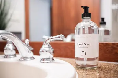 a bottle of hand soap sitting on a bathroom sink at Taluswood Bluffs by Outpost Whistler in Whistler