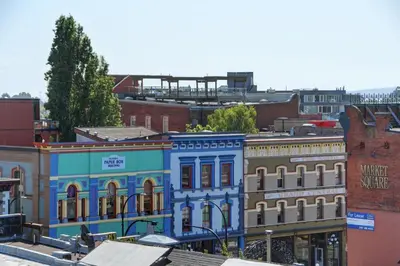 a blue building in the middle of a city at Unique Style 2 Bedroom 2 Bath Condo In Old Town Victoria in Victoria