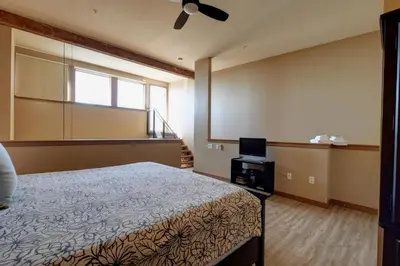 a bedroom with a bed and a window and a television at Unique Style 2 Bedroom 2 Bath Condo In Old Town Victoria in Victoria