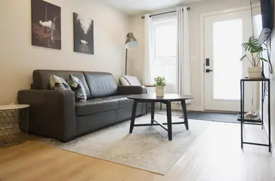 a living room with a couch and a table at Enchanted Mountain Getaway in Canmore