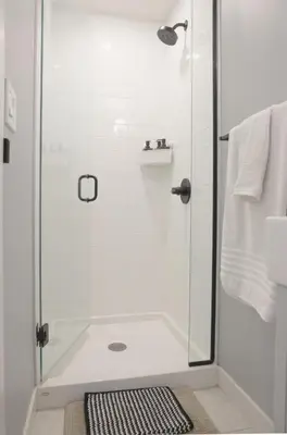 a bathroom with a shower with a glass door at Enchanted Mountain Getaway in Canmore