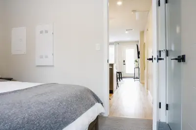 a bedroom with a bed and a hallway at Enchanted Mountain Getaway in Canmore