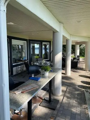 a patio with a table and chairs on a building at Saanichton Waterfront 2BR suite with superb views in Saanichton