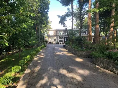 a brick path in front of a building with trees at Saanichton Waterfront 2BR suite with superb views in Saanichton