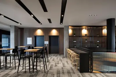 a restaurant with tables and chairs and a bar at Alt Hotel Calgary University District in Calgary