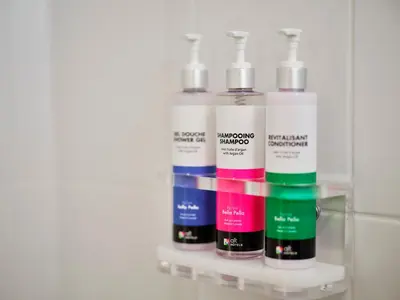 a group of four bottles on a shelf at Alt Hotel Calgary University District in Calgary