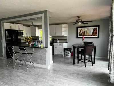 a kitchen and dining room with a table and chairs at Grie hunting quite room! in Calgary