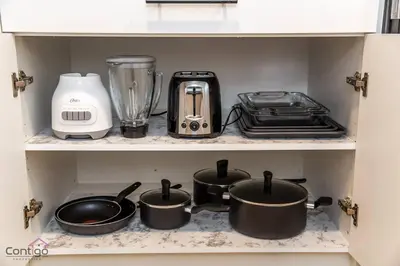 a kitchen shelf with pots and pans and a blender at Luxe New York Style Bsmt Suite, Near DT & WEM, King Bed, WiFi in Edmonton