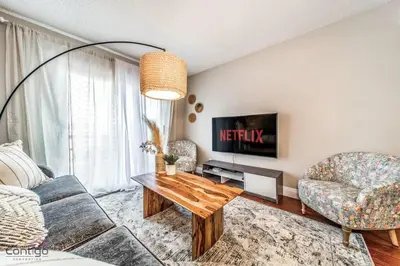 a living room with a couch and a table at Cozy 3BD w/AC, Patio, Theatre Room, 15 min to DT in Edmonton