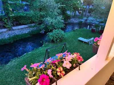 a flower box with pink flowers on a balcony at Kelowna little Island near Downtown, lake, hospital and Okanagan Collage in Kelowna