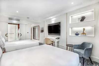 a hotel room with a bed and a tv at AZUR Legacy Collection Hotel in Vancouver