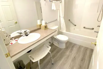 a bathroom with a sink and a toilet and a shower at Super 8 by Wyndham Sicamous in Sicamous