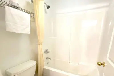 a bathroom with a shower and a toilet at Super 8 by Wyndham Sicamous in Sicamous