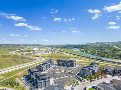 an aerial view of a city with buildings and a river at Rockland Oasis: 1BR + Parking in Calgary