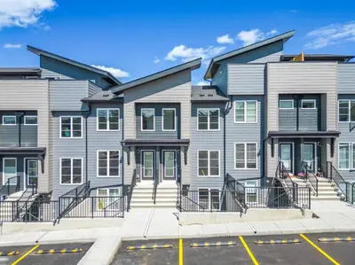 a row of houses on a street with a parking lot at Rockland Oasis: 1BR + Parking in Calgary