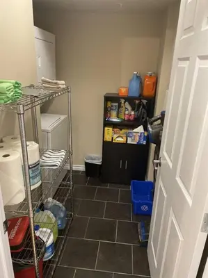 a room with a kitchen with a tiled floor at Chris's Cozy Condo Times Square Rogers Place Edmonton in Edmonton