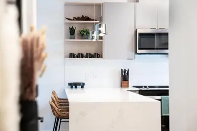 a kitchen with white cabinets and a white counter top at Prime Revy Penthouse in Revelstoke