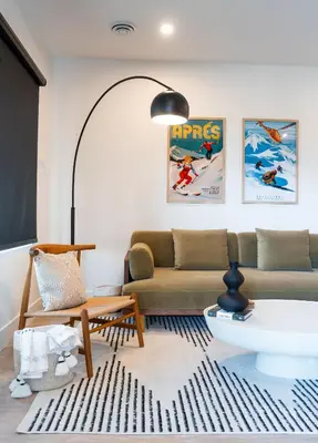 a living room with a couch and a table at Prime Revy Penthouse in Revelstoke