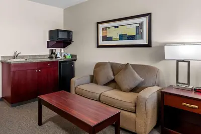 a living room with a couch and a coffee table at SureStay Hotel by Best Western Bassano in Bassano