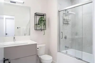 a bathroom with a shower and a toilet and a sink at Ghost Peak by Revelstoke Vacations in Revelstoke
