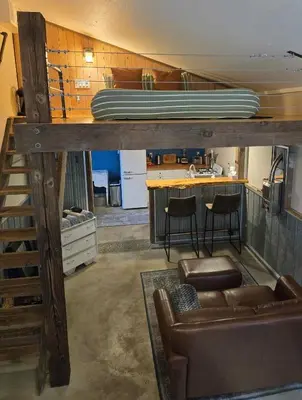 a living room with a bunk bed and a couch at Tiny house & Sauna on Lakefront Farm Oasis in Merville