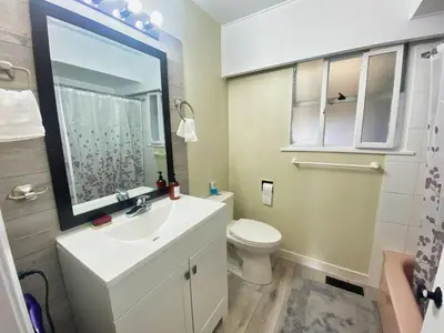 a bathroom with a sink and a toilet at Spacious home 15mins to Downtown in Vancouver