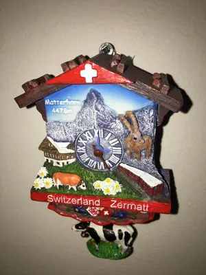 a clock with a picture of a mountain and a clock at The Blue Cottage B&B in Seventy Mile