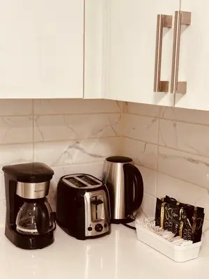a kitchen counter with a toaster and a coffee maker at unit #203 Cozy Mountain View 1BR in DT in Canmore