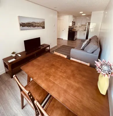 a living room with a table and a couch at unit #203 Cozy Mountain View 1BR in DT in Canmore