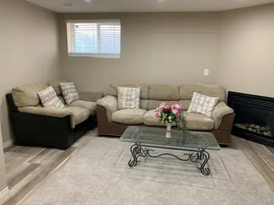 a living room with a couch and a coffee table at Divine Homes in Calgary
