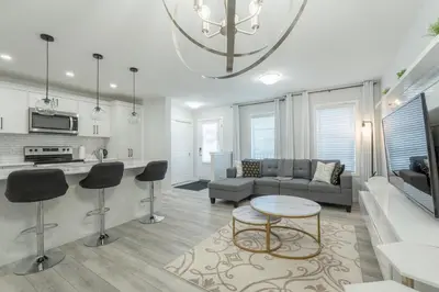 a living room with a couch and a table at 3bedroom Stylish Getaway by the Park with 2-Car Garage in Calgary