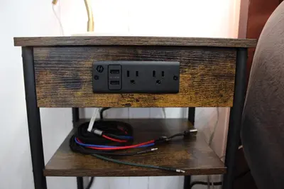 a electrical outlet on a wooden table with wires at Private Bright Modern Studio! Queen bed ! in Victoria