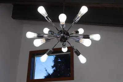 a chandelier hanging in a room with a window at Private Bright Modern Studio! Queen bed ! in Victoria