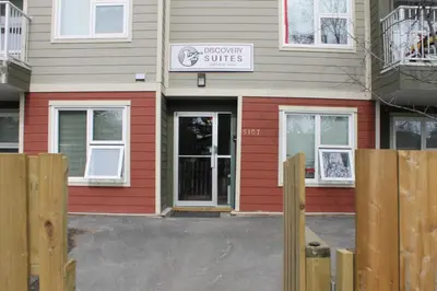 a building with a sign that reads mercy smiles at Discovery Suite in Yellowknife