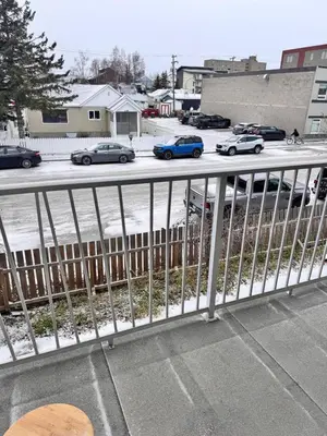a balcony with cars parked in a parking lot at Discovery Suite in Yellowknife