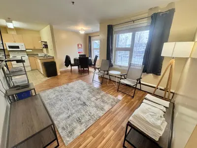 a large living room with a kitchen and a dining room at Discovery Suite in Yellowknife