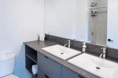 a bathroom with two sinks and a toilet at Stoke House by Revelstoke Vacations in Revelstoke